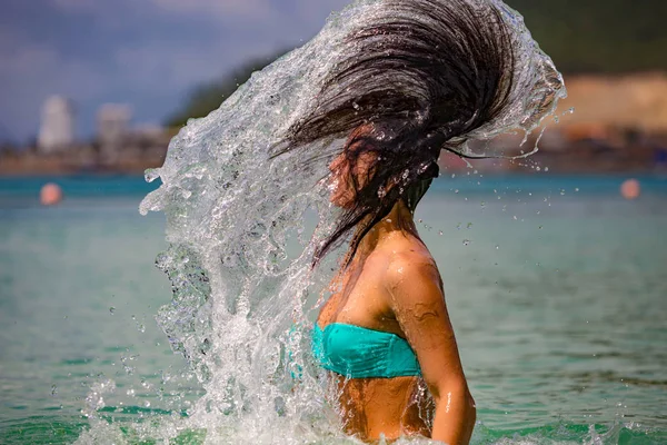 Woman making hair splashes
