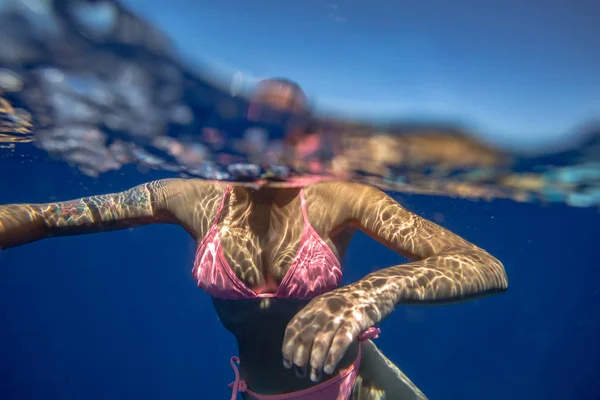 Flickan under vattnet i blå havet — Stockfoto