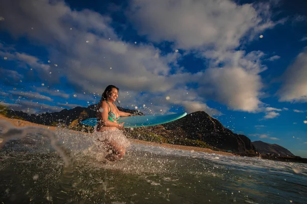 Surfer girl with a board in the water — Stock Photo, Image