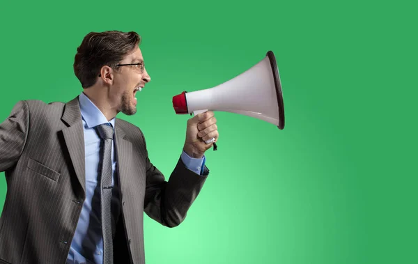 Businessman in gray suit with megaphone — Stock Photo, Image