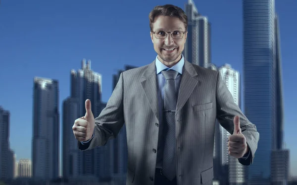 Businessman in gray suit smiling and both thumbs up — Stock Photo, Image