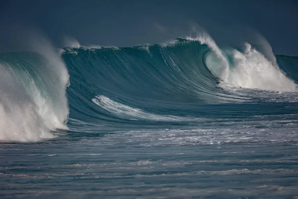 Huge waves crashing in ocean. Seascape environment background. Water texture with foam and splashes. Hawaiian surfing spots with nobody