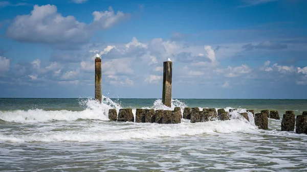 Spetterende golven van de Noordzee op de houten golfbrekers van th — Stockfoto