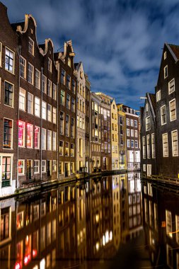 Amsterdam kanalları ve evleri Amsterdam 'ın gece manzarasına karşı