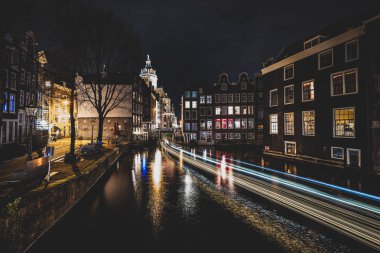 Amsterdam kanalları ve evleri Amsterdam 'ın gece manzarasına karşı