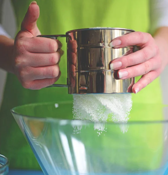 Flour sifting through a sieve for a baking — Stock Photo, Image