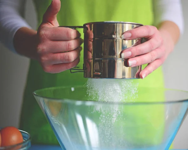 Flour sifting through a sieve for a baking — Stock Photo, Image