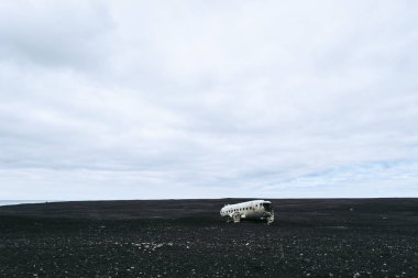 Wrecked plane on the black sand beach in Iceland. Atmospheric Icelandic landscape