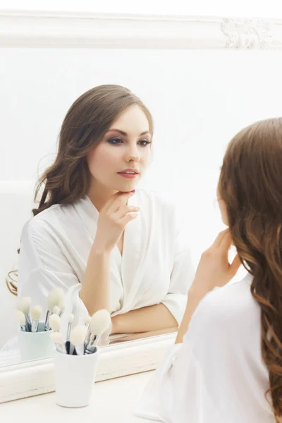 Beautiful girl looking at mirror — Stock Photo, Image