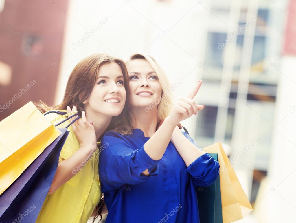 Young and happy women with shopping bags 