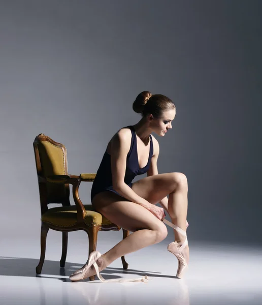 Балерина вяжет ленты на пуантах — стоковое фото