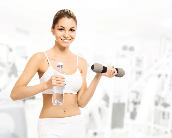 Mujer con mancuerna y botella — Foto de Stock