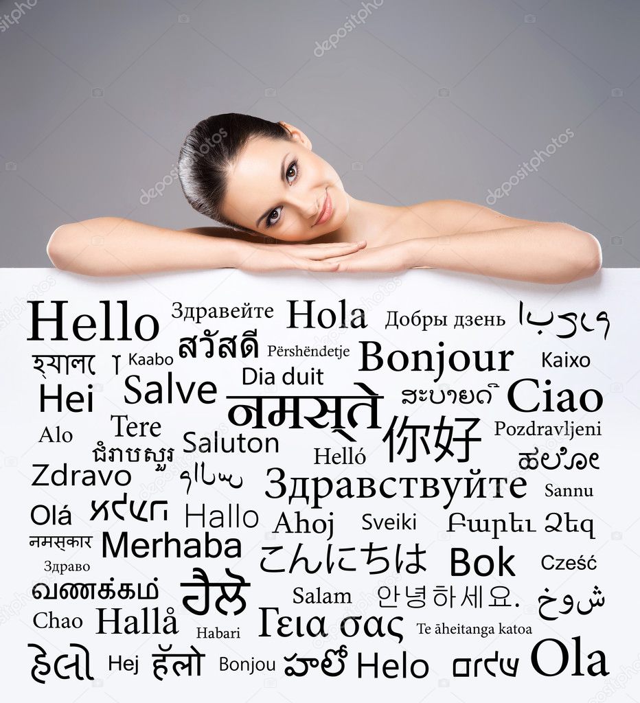 woman behind banner with words of different languages