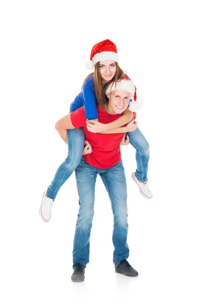 Happy couple in red Christmas hats — Stock Photo, Image