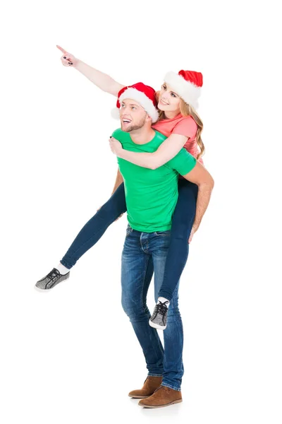 Happy couple in red Christmas hats — Stock Photo, Image