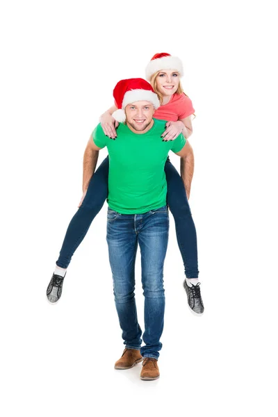 Casal feliz em chapéus de Natal vermelho — Fotografia de Stock