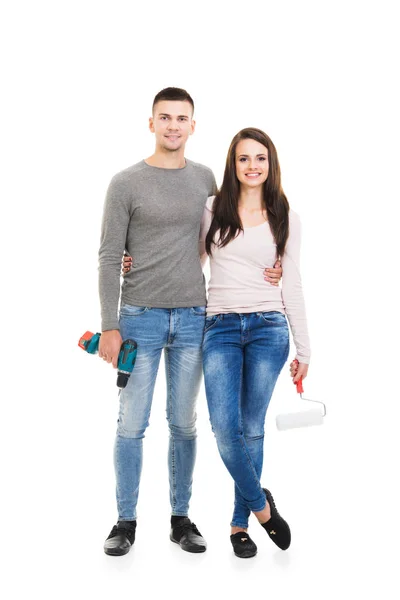 Young man and woman holding tools — Stock Photo, Image