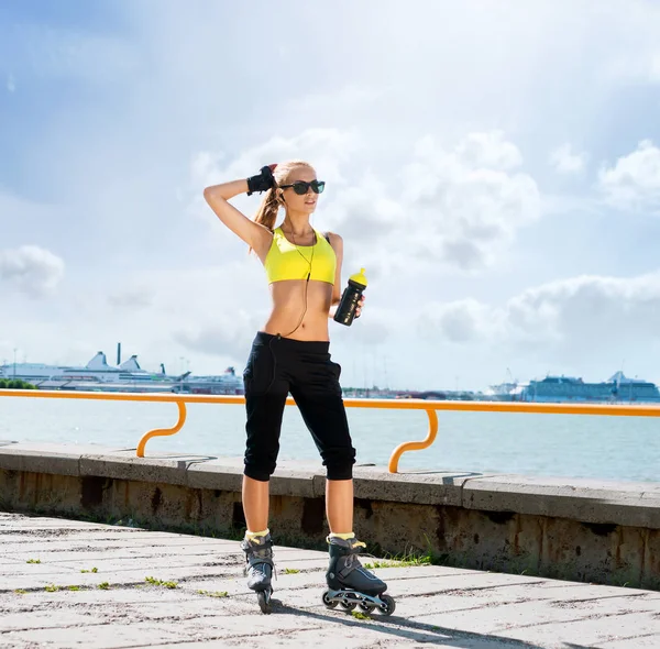 Young and sporty woman rollerblading on skates — Stock Photo, Image