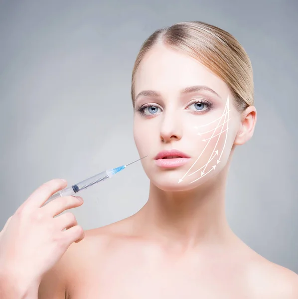 Doctor making injection into face of woman — Stock Photo, Image