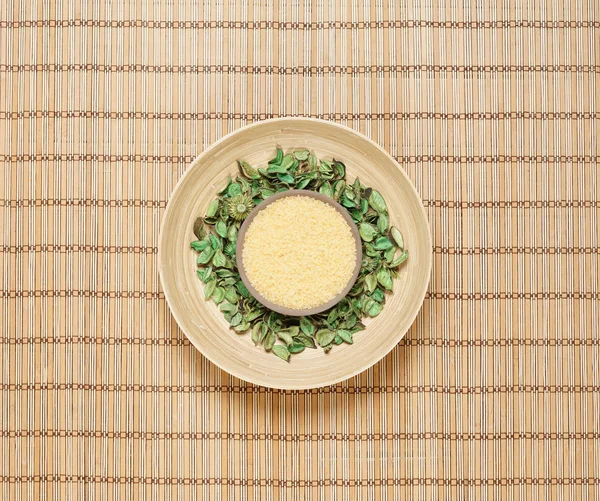 Plate with aroma petals on bamboo mat — Stock Photo, Image