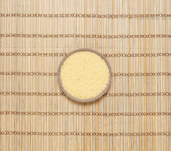 Plate with bath salt on bamboo mat — Stock Photo, Image