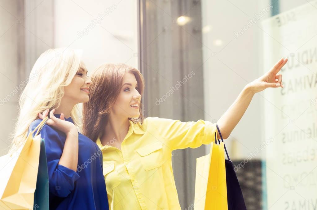 Young and happy women with shopping bags 
