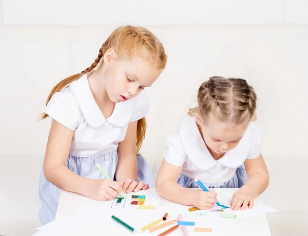 Two beautiful, cute little girls are drawing. Family, home concept — Stock Photo, Image