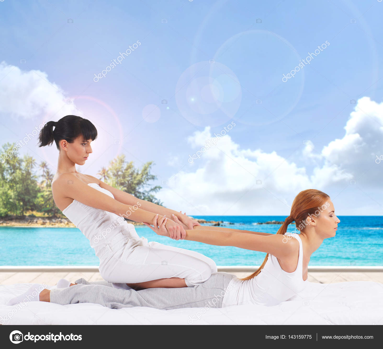 Woman getting thai stretching massage Stock Photo by ©shmeljov 143159775