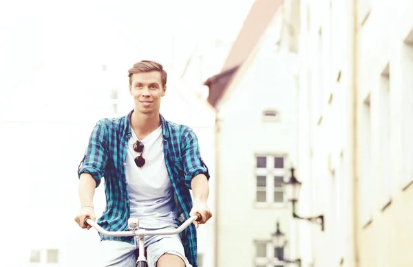 Young man riding bicycle — Stock Photo, Image