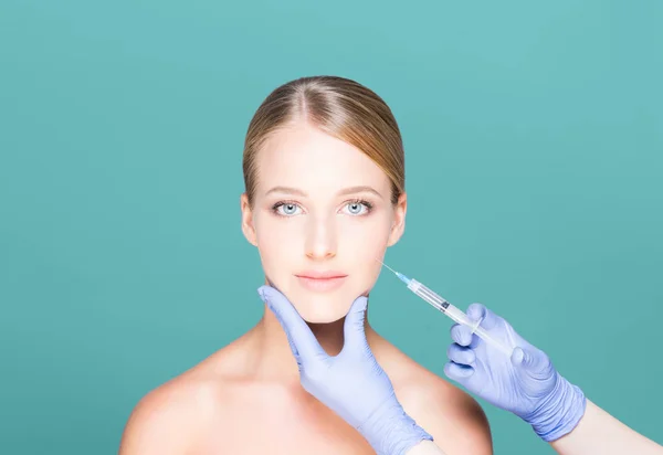 Doctor making injection into face of woman — Stock Photo, Image