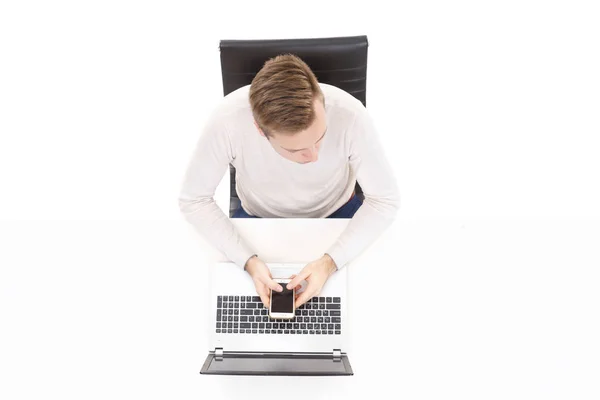 Handsome guy sitting at white table — Stock Photo, Image