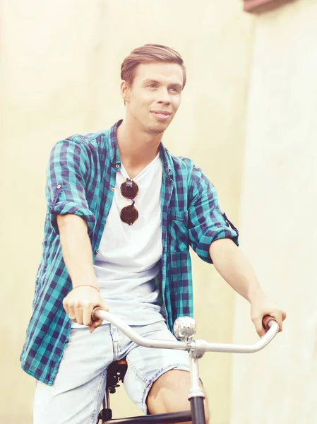 Young man riding bicycle — Stock Photo, Image