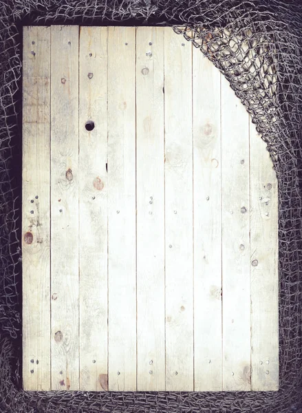 Visnetten op houten planken — Stockfoto