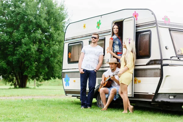 happy friends at camper trailer