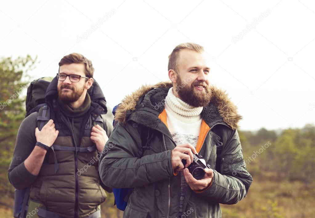 two men hiking in forest