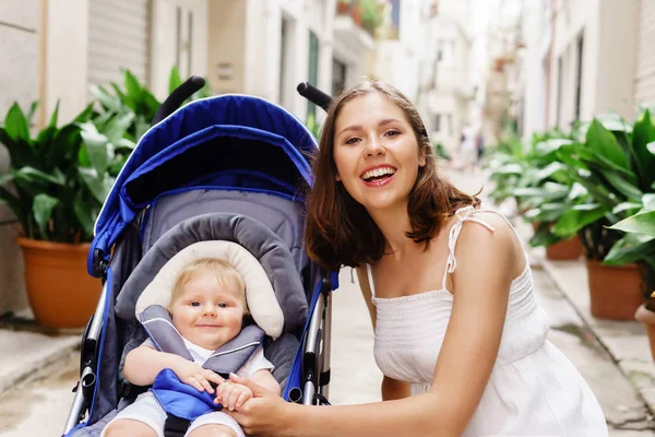 Mother with cute baby in pram — Stock Photo, Image