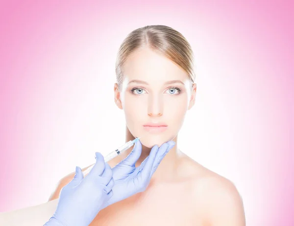 Doctor making injection into face of woman — Stock Photo, Image