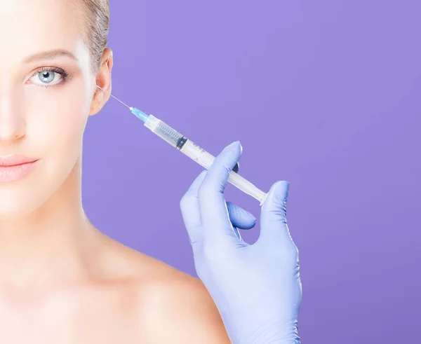 Doctor making injection into face of woman — Stock Photo, Image