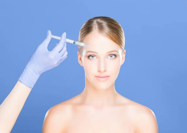 Dokter maken van injectie in gezicht van vrouw — Stockfoto