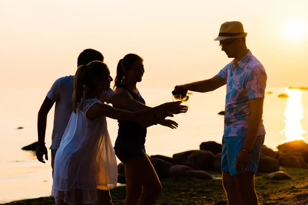 Přátelé se těší západ slunce a pít šampaňské — Stock fotografie