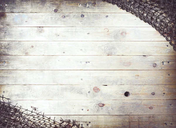 Fishing nets on wooden planks — Stock Photo, Image