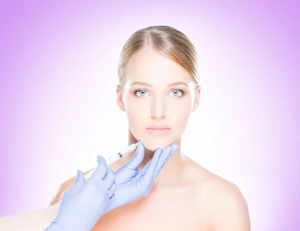 Doctor making injection into face of woman — Stock Photo, Image