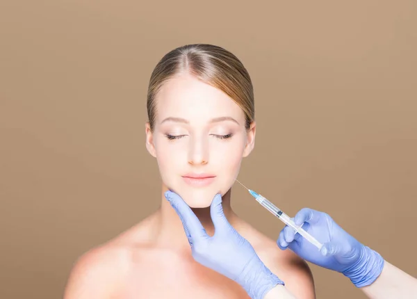 Dokter maken van injectie in gezicht van vrouw — Stockfoto