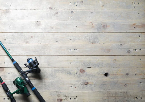 Fishing rods on wooden planks — Stock Photo, Image