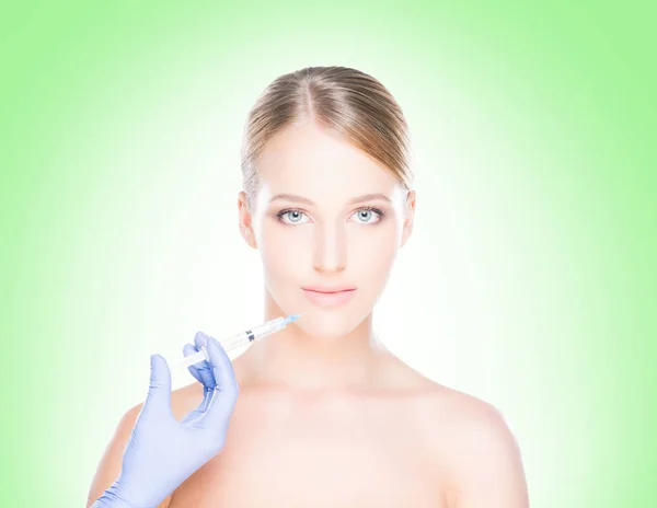 Doctor making injection into face of woman — Stock Photo, Image