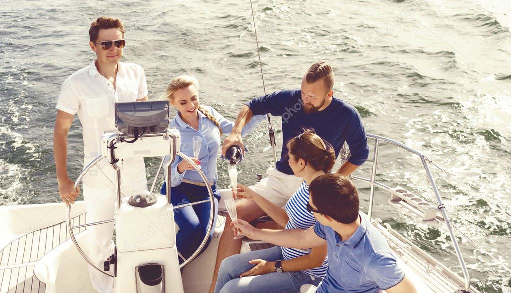 happy friends traveling on yacht