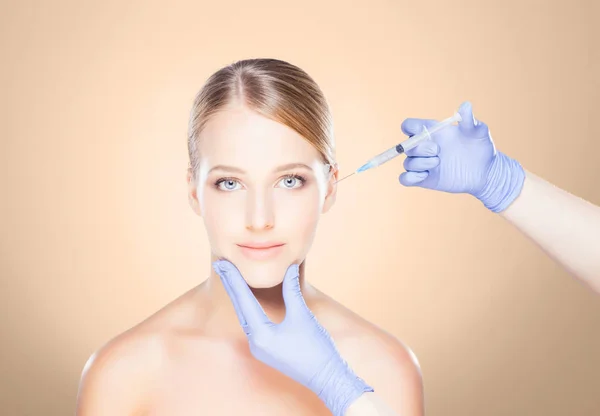 Doctor making injection into face of woman — Stock Photo, Image