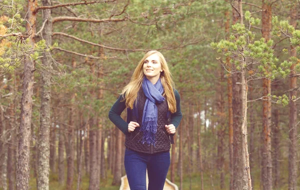 Young woman walking in forest — Stock Photo, Image