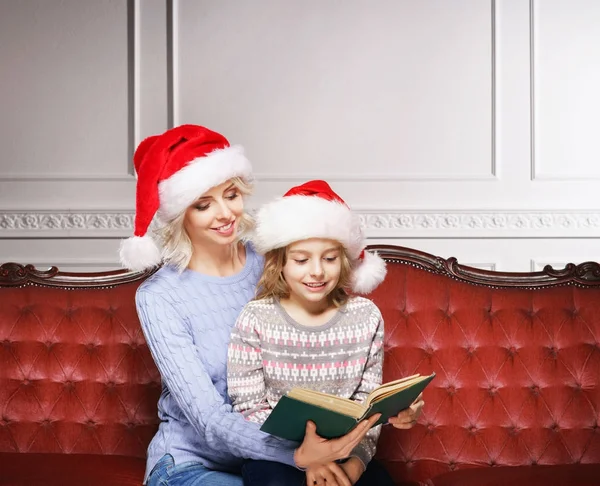 Mother and daughter reading book on Christmas — Stock Photo, Image