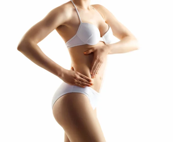 Perfect lichaam van slank, fit en sportief meisje in ondergoed geïsoleerd op wit. — Stockfoto